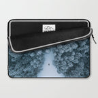 Man lying in the snow on a frozen lake in a winter forest - Landscape Photography Laptop Sleeve Gallery Image 2