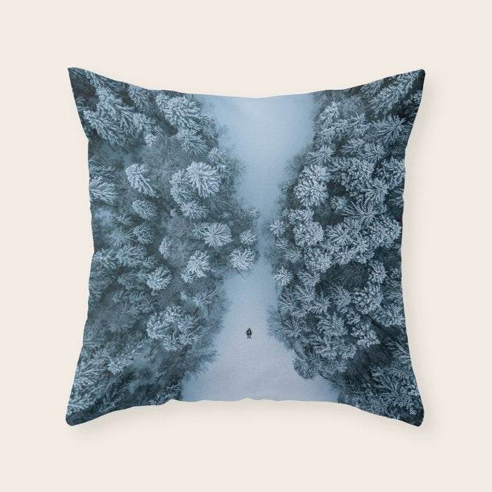 Man lying in the snow on a frozen lake in a winter forest - Landscape Photography Throw Pillow Gallery Image 1