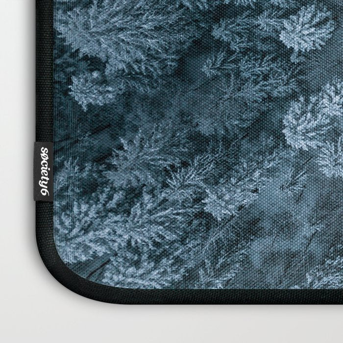 Man lying in the snow on a frozen lake in a winter forest - Landscape Photography Laptop Sleeve Gallery Image 3