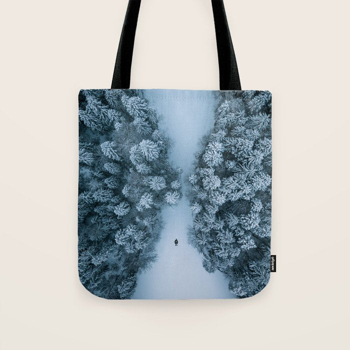 Man lying in the snow on a frozen lake in a winter forest - Landscape Photography Tote Bag Gallery Image 1
