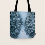 Man lying in the snow on a frozen lake in a winter forest - Landscape Photography Tote Bag Gallery Image 1