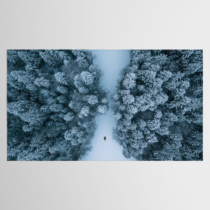 Man lying in the snow on a frozen lake in a winter forest - Landscape Photography Tablecloth Gallery Image 2