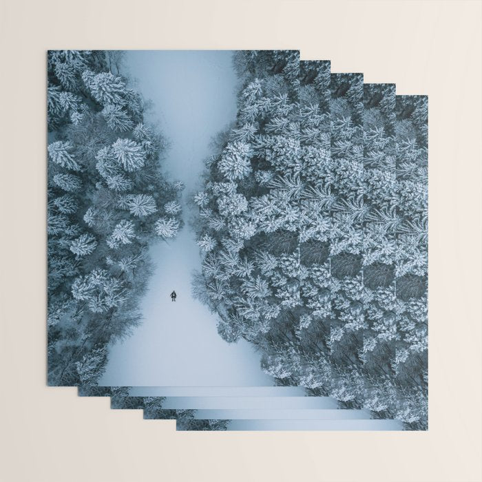 Man lying in the snow on a frozen lake in a winter forest - Landscape Photography Wrapping Paper Gallery Image 3