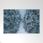 Man lying in the snow on a frozen lake in a winter forest - Landscape Photography Welcome Mat Gallery Image 1