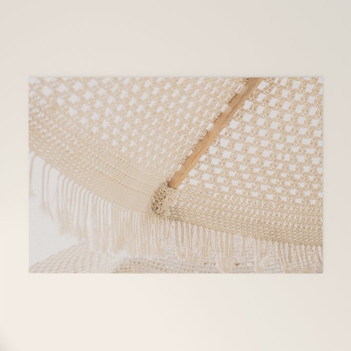 Boho crochet beach umbrella close-up, neutral minimalist summer photo Welcome Mat Gallery Image 1