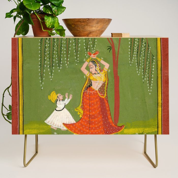 A female attendant is standing in tribhanga pose under a tree. A small child vies for her attention. Credenza Gallery Image 1