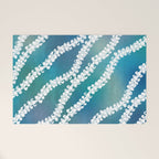 Puakenikeni single lei art on blue Welcome Mat Gallery Image 1