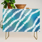 Puakenikeni single lei art on blue Credenza Gallery Image 1