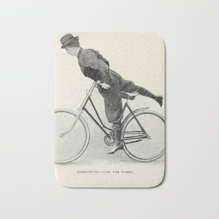 "Dismounting Over the Wheel" from "Bicycling for Ladies" by Maria E. Ward, 1896 Bath Mat Gallery Image 1