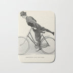 "Dismounting Over the Wheel" from "Bicycling for Ladies" by Maria E. Ward, 1896 Bath Mat Gallery Image 1