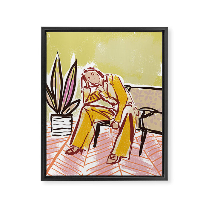 Woman sitting on sofa Framed Canvas Print Gallery Image 1