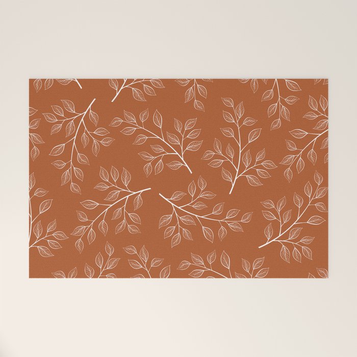 Delicate White Leaves and Branch on a Rust Orange Background Welcome Mat Gallery Image 1