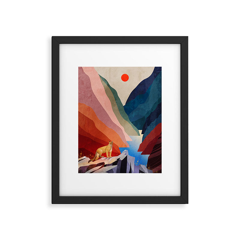 Mountain lion standing on a rock Framed Art Print