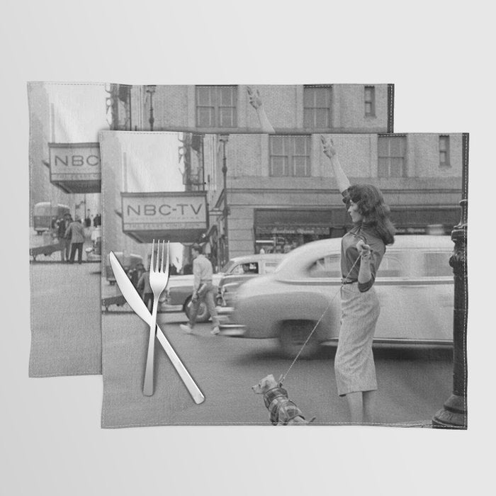 Young woman with pet dog hailing a yellow cab taxi New York City portrait black and white photograph - photography - photographs Placemat Gallery Image 1