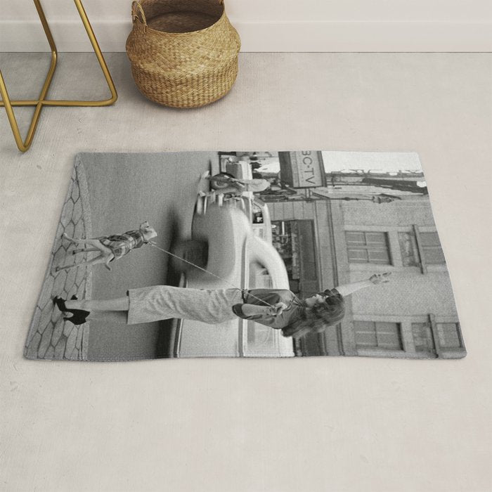 Young woman with pet dog hailing a yellow cab taxi New York City portrait black and white photograph - photography - photographs Rug Gallery Image 1