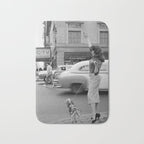 Young woman with pet dog hailing a yellow cab taxi New York City portrait black and white photograph - photography - photographs Bath Mat Gallery Image 1