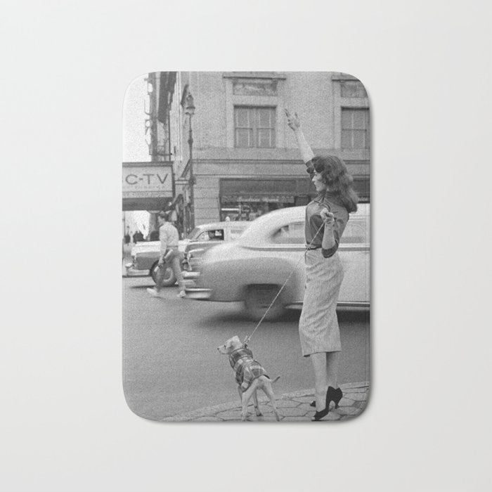 Young woman with pet dog hailing a yellow cab taxi New York City portrait black and white photograph - photography - photographs Bath Mat Gallery Image 1