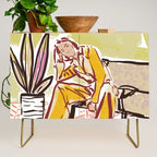 Woman sitting on sofa Credenza Gallery Image 1