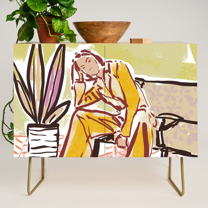 Woman sitting on sofa Credenza Gallery Image 1