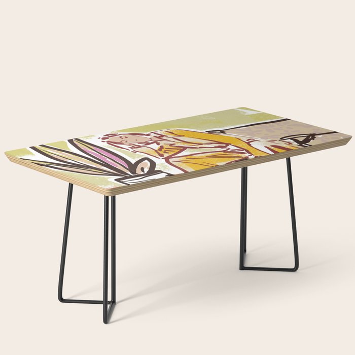 Woman sitting on sofa Coffee Table Gallery Image 1