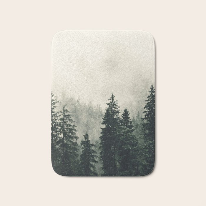 Thick pine forest in the descending mist Bath Mat Gallery Image 1