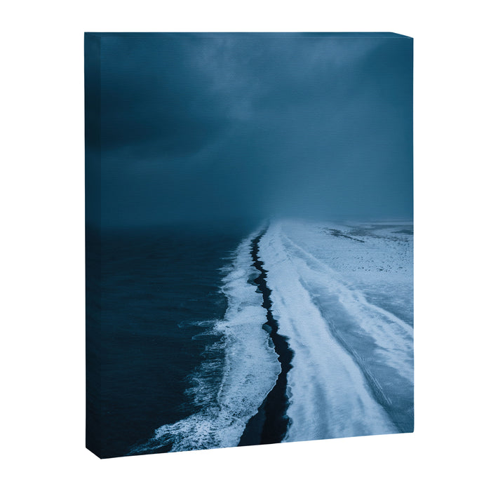 Black Sand Beach with snow in Iceland during a storm â Moody Landscape Photography Canvas Print Gallery Image 1