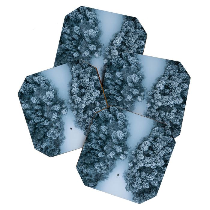 Man lying in the snow on a frozen lake in a winter forest - Landscape Photography Coaster Gallery Image 1