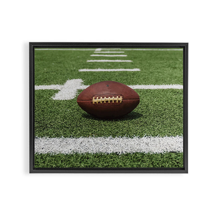 American Football Court with ball on Gras Framed Canvas Print Gallery Image 1