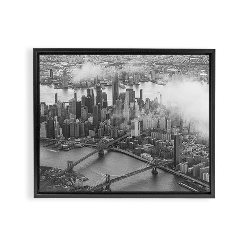 Manhattan Through The Clouds Framed Canvas Print